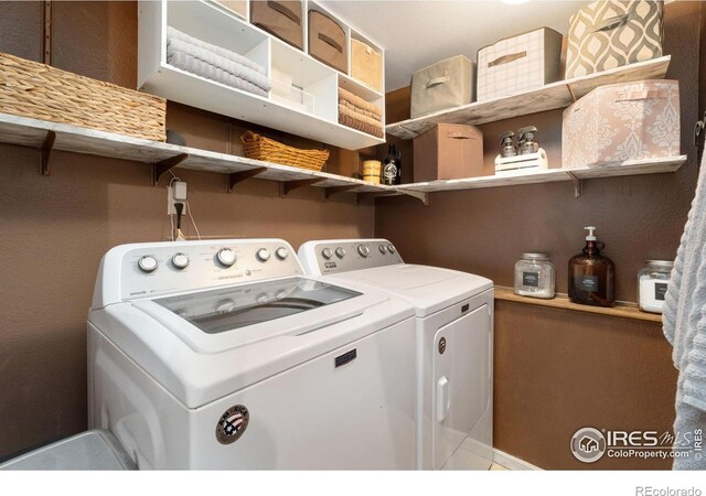 clothes washing area featuring independent washer and dryer