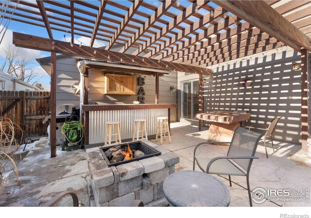 view of patio / terrace with a pergola, a fire pit, and a bar