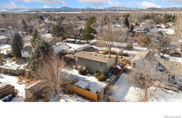 snowy aerial view with a mountain view