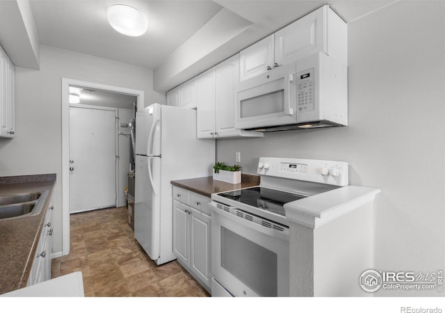 kitchen with white cabinetry, white appliances, and sink