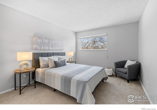 carpeted bedroom featuring a textured ceiling