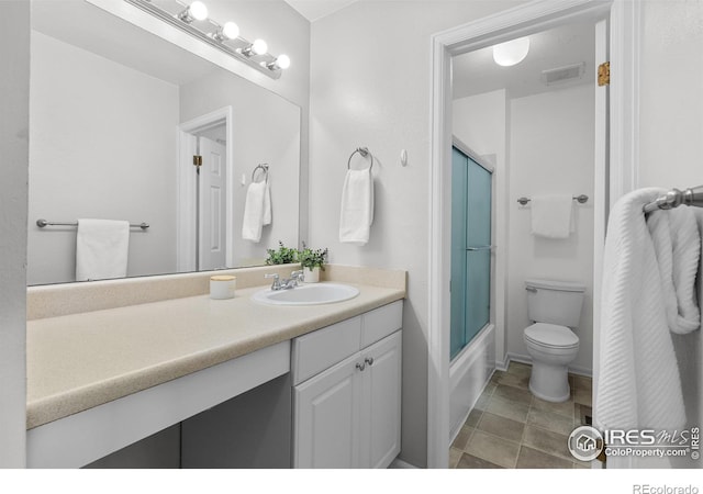 full bathroom with vanity, shower / bath combination with glass door, and toilet