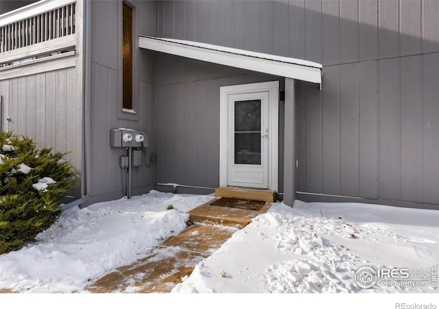 view of snow covered property entrance