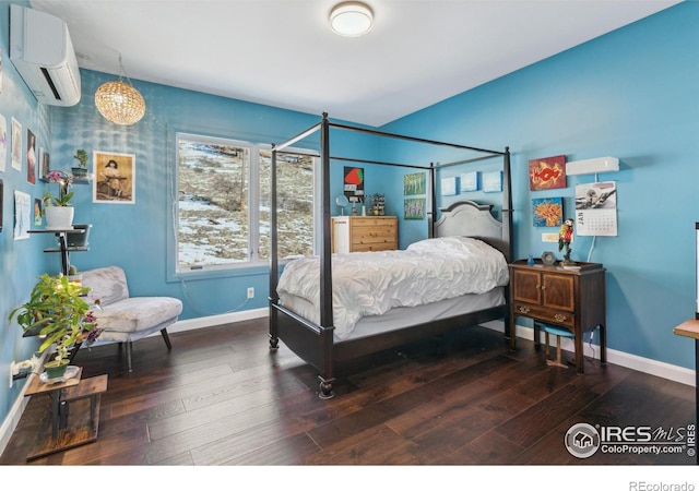 bedroom featuring dark hardwood / wood-style flooring and an AC wall unit