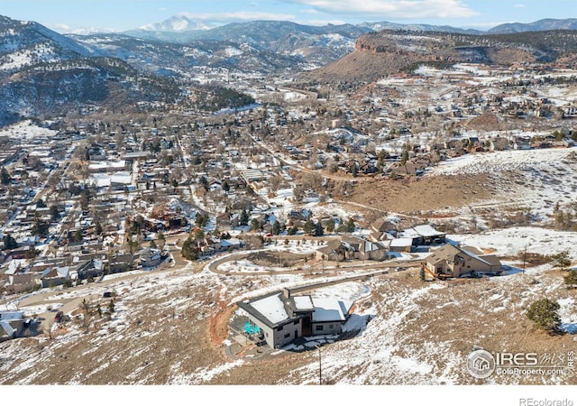 snowy aerial view featuring a mountain view