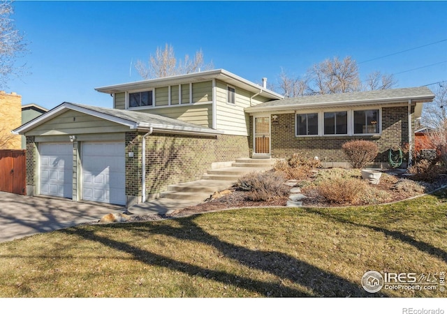 split level home with a garage and a front lawn