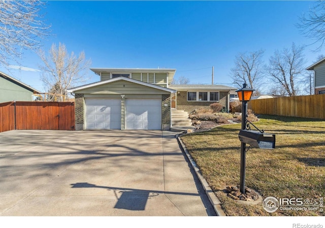 view of front of property featuring a garage and a front yard