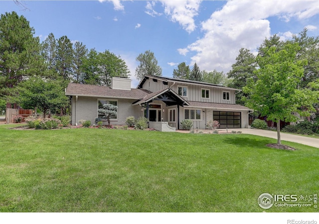 view of front of property featuring a garage and a front lawn