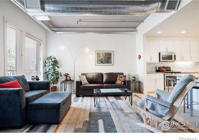 living room with light hardwood / wood-style flooring