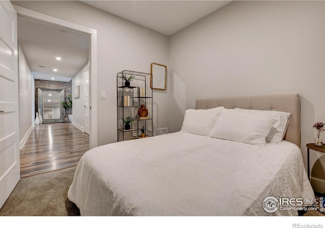 bedroom featuring dark colored carpet