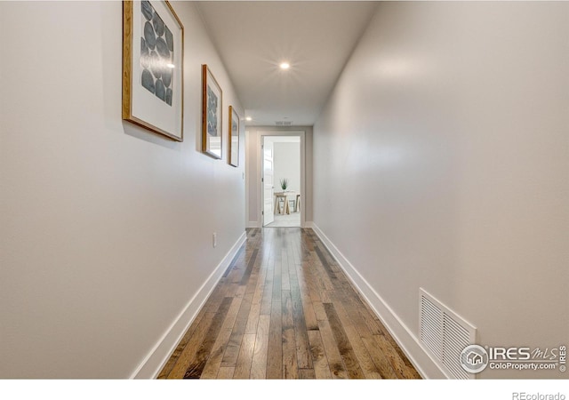 hall with hardwood / wood-style flooring