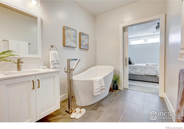 bathroom featuring vanity and a washtub