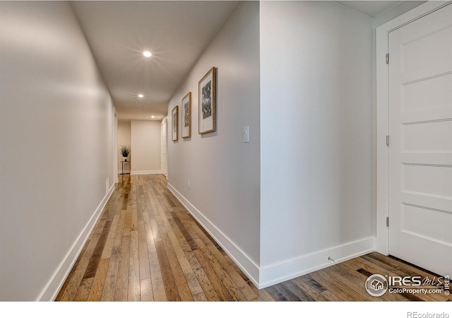 hall with wood-type flooring