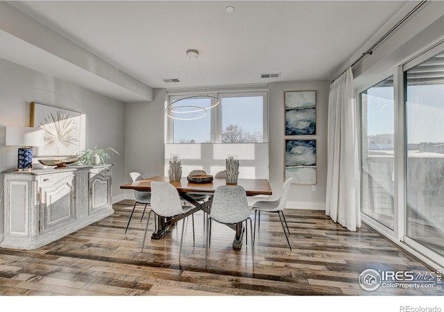 dining space with hardwood / wood-style floors