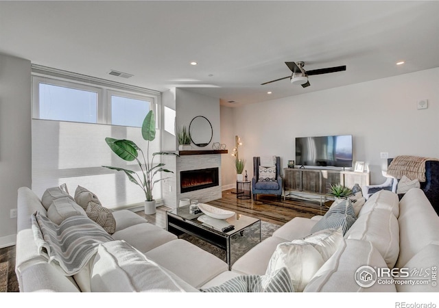 living room featuring hardwood / wood-style flooring and ceiling fan