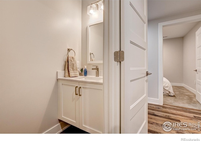 bathroom with vanity and wood-type flooring