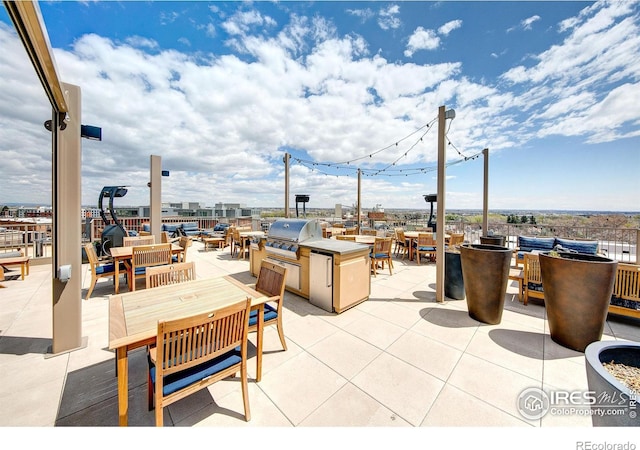 view of patio / terrace featuring a grill and an outdoor kitchen