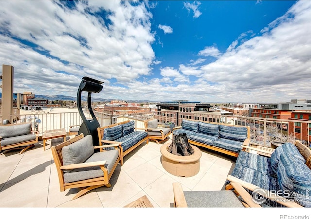 view of patio / terrace featuring an outdoor living space with a fire pit