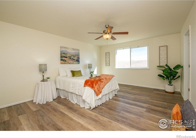 bedroom featuring hardwood / wood-style flooring and ceiling fan