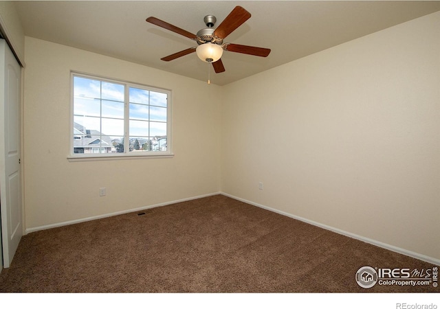 unfurnished room featuring ceiling fan and carpet flooring