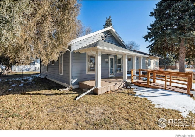 bungalow-style home with a front lawn and a porch