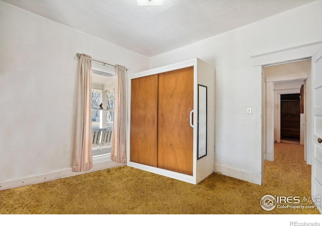 unfurnished bedroom featuring a closet and carpet flooring