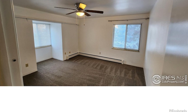 unfurnished room featuring a baseboard heating unit, dark colored carpet, ceiling fan, and baseboards