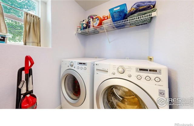 clothes washing area featuring washer and clothes dryer