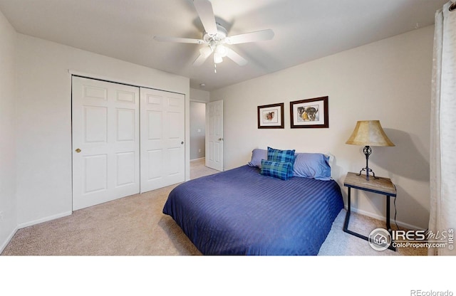 bedroom featuring light colored carpet, a closet, and ceiling fan