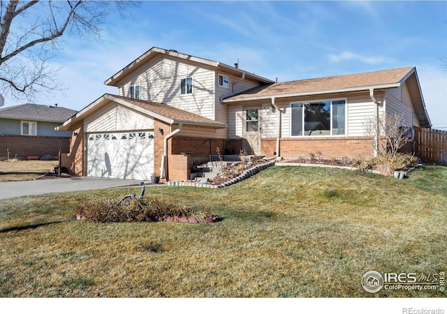 tri-level home with a garage and a front yard