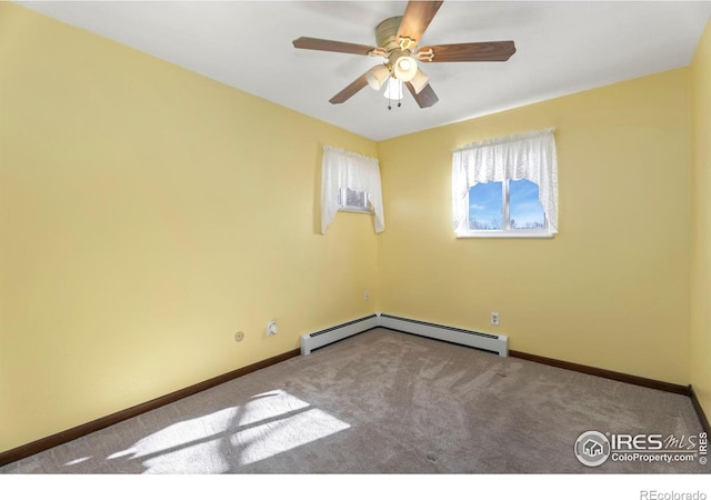 carpeted spare room with a baseboard radiator and ceiling fan