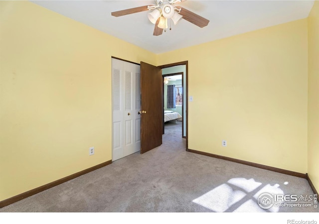 carpeted empty room featuring ceiling fan