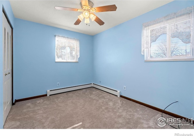 unfurnished bedroom with a baseboard heating unit, light carpet, ceiling fan, and a closet