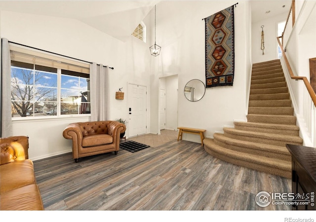 interior space with wood-type flooring and high vaulted ceiling