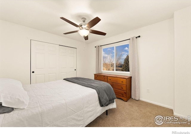 carpeted bedroom with ceiling fan and a closet