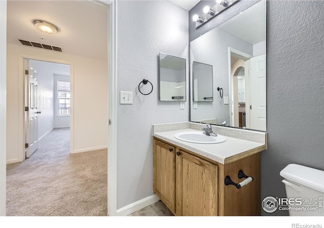 bathroom with vanity and toilet