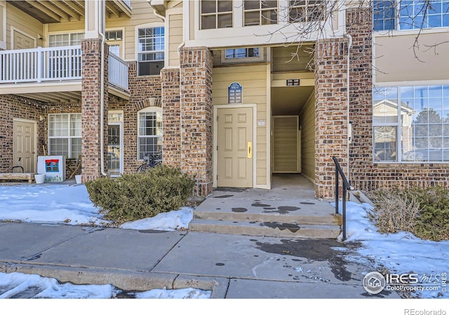 view of snow covered property entrance