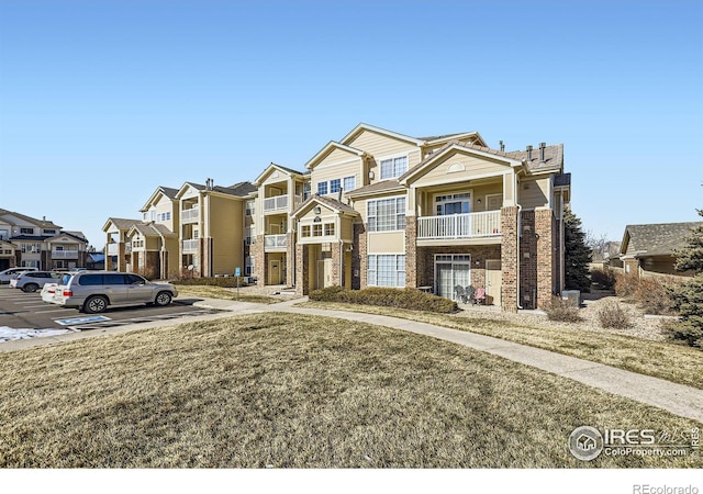 5756 N Genoa Way Unit 205, Aurora, CO 80019 - view of property with uncovered parking, a residential view, and brick siding