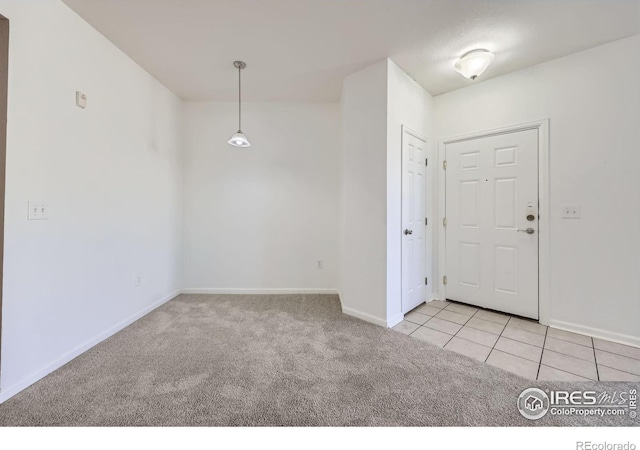 5756 N Genoa Way Unit 205, Aurora, CO 80019 - carpeted spare room featuring baseboards and tile patterned floors