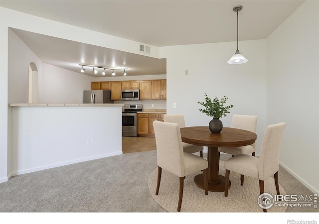 5756 N Genoa Way Unit 205, Aurora, CO 80019 - dining area with light colored carpet and baseboards