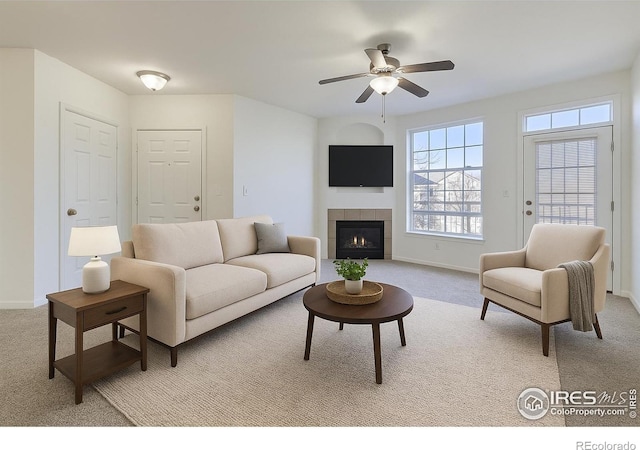 5756 N Genoa Way Unit 205, Aurora, CO 80019 - living room featuring light carpet, ceiling fan, and a tile fireplace