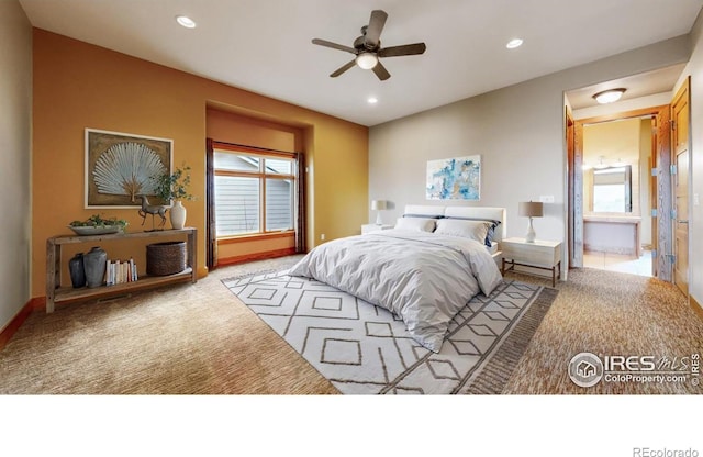 bedroom with light carpet, connected bathroom, and ceiling fan