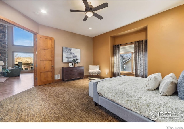 bedroom with multiple windows, carpet, visible vents, and recessed lighting