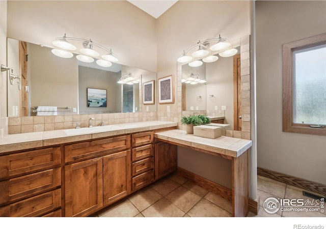 full bathroom with backsplash, vanity, and tile patterned floors