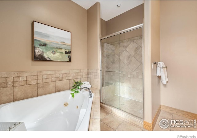 full bath featuring a stall shower and a jetted tub