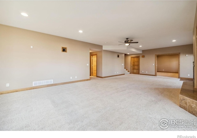 unfurnished living room with a ceiling fan, recessed lighting, visible vents, and stairs