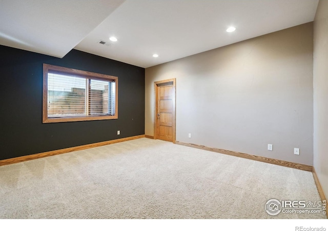 carpeted empty room featuring recessed lighting, visible vents, and baseboards