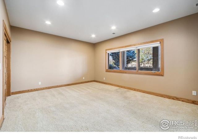 empty room featuring baseboards, carpet floors, and recessed lighting