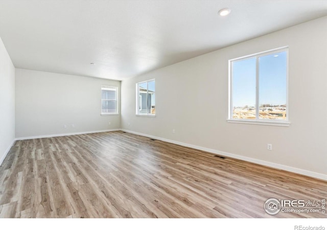 spare room with light hardwood / wood-style flooring