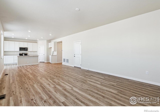 unfurnished living room with light wood-type flooring